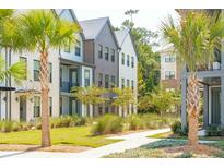 Charming townhomes with well-manicured lawns and beautiful landscaping, including palm trees and ornamental trees at 1515 Hidalgo Dr, Mount Pleasant, SC 29464