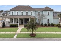 Charming two-story home featuring a welcoming front porch and well-manicured lawn at 1556 Cranes Nest Rd, Mount Pleasant, SC 29466