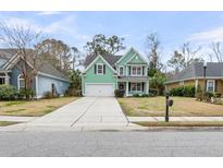 Charming two-story home with a well-manicured lawn, green siding, attached garage, and inviting curb appeal at 2085 Terrabrook Ln, Charleston, SC 29412