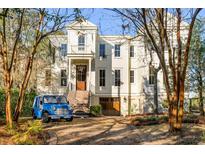 Charming two-story home with landscaped yard, front stairs, garage and a blue Moke at 26 Saturday Rd, Mount Pleasant, SC 29464