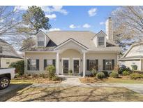 Charming townhouse exterior with neutral siding, dormer windows, covered entry and well-maintained landscaping at 4850 Habersham Ln, Summerville, SC 29485