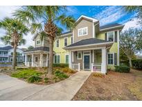 Charming two-story townhouse with palm trees, manicured lawn, and inviting entryway with an American flag at 1225 Blakeway St # 406, Charleston, SC 29492