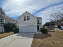 Charming two-story home with a well-maintained lawn and a two-car garage at 1501 Mcintosh Road, Johns Island, SC 29455