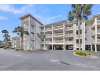 Coastal condo building with multi-level decks, palms, and covered parking at 2017 Long Bend Dr, Seabrook Island, SC 29455