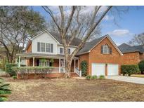 Charming two-story brick and vinyl home with a covered porch and manicured landscaping at 2072 Middleburg Ln, Mount Pleasant, SC 29464