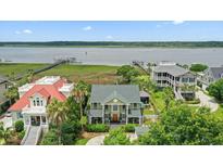 Stunning waterfront home with a green roof, lush landscaping, and neighborhood docks at 2156 Cheswick Ln, Mount Pleasant, SC 29466