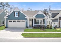 Charming single-story home with a well-manicured lawn and a two-car attached garage at 222 River Martin Ct, Summerville, SC 29483