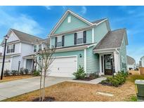 Charming two-story home with attached garage, manicured lawn, and welcoming entryway at 109 Forest Springs Rd, Moncks Corner, SC 29461