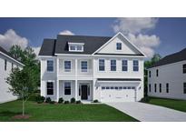 Charming two-story home featuring a second story balcony, attached two-car garage, and beautifully landscaped front yard at 151 Seaton Street, Summerville, SC 29486
