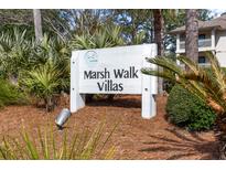 Marsh Walk Villas community sign amid lush landscaping and coastal foliage near the beach at 2012 Long Bend Drive, Seabrook Island, SC 29455