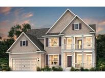 Charming two-story home boasts a covered porch, attached garage, and classic architectural details at 2106 Cousteau Ct, Johns Island, SC 29455