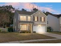 Charming two-story home featuring neutral siding, attached two-car garage, and well-manicured lawn at 212 Medford Dr, Summerville, SC 29485