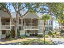 Charming two-story condo featuring a private balcony, lush landscaping and inviting curb appeal at 2135 Landfall Way, Seabrook Island, SC 29455