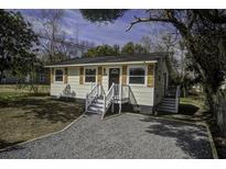 Charming home with a gravel driveway and freshly painted exterior at 2218 Dover St, North Charleston, SC 29405