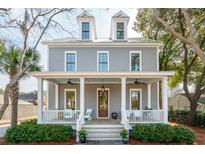 Charming two-story home with a welcoming front porch, dormer windows, and landscaped yard at 425 Mccants Dr, Mount Pleasant, SC 29464
