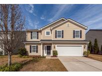 Charming two-story home featuring a manicured lawn, attached two-car garage and classic curb appeal at 426 Mountain Laurel Cir, Goose Creek, SC 29445
