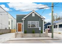 Charming home features a tidy, dark green exterior, a quaint front yard and modern design at 5 Maranda Holmes St, Charleston, SC 29403