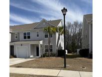 Charming home with gray siding, well-manicured lawn, and palm trees in the front yard at 618 Hilchot Dr, Summerville, SC 29486