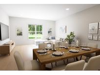Bright dining area features wood table set for a meal and lots of natural light at 7626 Indigo Palms Way, Johns Island, SC 29455