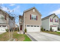 Charming two-story home featuring a two-car garage, well-maintained lawn, and appealing curb appeal at 9009 Cat Tail Pond Rd, Summerville, SC 29485
