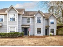 Charming gray townhouse with an inviting front entrance and well-maintained landscaping at 1662 Hunters Run Dr, Mount Pleasant, SC 29464