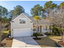 Charming single-Gathering home featuring an attached garage, well-manicured lawn, and inviting front porch at 2176 Andover Way, Mount Pleasant, SC 29466