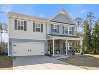 Charming two-story home with a covered porch and well-manicured landscaping at 301 Dunlin Dr, Summerville, SC 29486