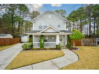 Charming two-story home featuring a cozy front porch and well-maintained landscaping at 3041 Nehemiah Rd, Mount Pleasant, SC 29466
