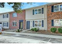 Charming townhome with brick and siding exterior, dark shutters, well-maintained landscaping, and convenient parking spaces at 415 Parkdale Dr # 12D, Charleston, SC 29414