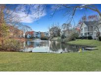 Scenic view of pond with fountain and surrounding homes under a bright blue sky at 6275 Rolling Fork Rd # C, North Charleston, SC 29406