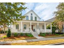 Charming two-story home featuring a spacious porch with white columns and a well-maintained front yard at 894 Tupelo Bay Dr, Mount Pleasant, SC 29464