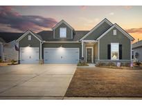 Charming two-story home with a three-car garage and well-manicured lawn at 1107 Bellwether Ln, Summerville, SC 29485