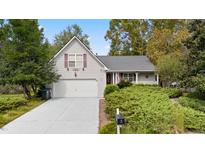 Charming single-Gathering home with gray siding, lush landscaping, and a well-manicured front yard at 132 Lipman St, Summerville, SC 29483