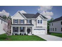 Charming two-story home with gray siding, black shutters, a covered porch, and an attached two-car garage at 135 Seaton Street, Summerville, SC 29486