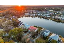 Scenic aerial view of the community and lake at sunset offering serene water views and upscale coastal living at 1429 Appling Dr, Mount Pleasant, SC 29464