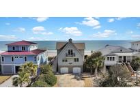Charming beach house featuring double garages, a balcony, and stunning ocean views, perfect for coastal living at 1615 E Ashley Ave, Folly Beach, SC 29439