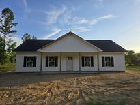 Charming single-story home with white siding, black shutters, and a welcoming front porch at 179 Hill Dr, Summerville, SC 29483