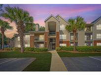 Beautiful condo complex with palm trees and well-maintained landscaping at sunset at 2011 N Highway 17 # 1400H, Mount Pleasant, SC 29466