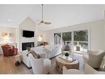 Bright living room featuring a fireplace, vaulted ceilings, and a seamless indoor-outdoor flow to the deck at 2276 Seascape Ct, Seabrook Island, SC 29455
