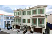 Charming new construction townhouse with green shutters, garage, and beautifully landscaped front yard at 4 Trapman St # B, Charleston, SC 29401