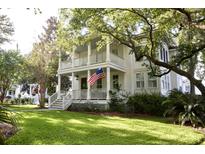 Charming two-story home with a lush green lawn, inviting porch, and beautiful trees at 713 Hibbens Grant Blvd, Mount Pleasant, SC 29464