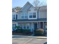 Charming two-story townhouse with light blue siding, white trim, and well-maintained landscaping at 120 Hornby Cir, Goose Creek, SC 29445