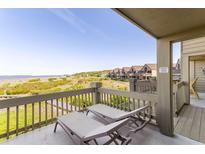 Relax on this private balcony with lounge chairs overlooking gorgeous views of the beach and coastline at 1346/48 Pelican Watch, Seabrook Island, SC 29455
