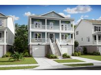 Inviting two-story home boasting double balconies, white railings, and a welcoming staircase at 1675 Cultivation Lane Dr # 458, Mount Pleasant, SC 29466