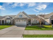 Charming single-story home with a two-car garage and manicured lawn at 2014 Barn Swallow Rd, Summerville, SC 29483