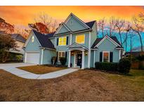 Charming two-story home features a well-manicured lawn and inviting entrance at 2124 Tall Grass Cir, Mount Pleasant, SC 29466