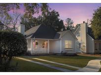 Charming single-story home with a quaint porch, well-manicured lawn, and welcoming curb appeal under a colorful sky at 2320 Chadbury Ln, Mount Pleasant, SC 29466