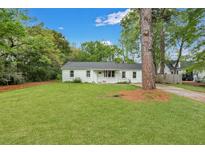 Charming single-story home with a well-manicured lawn and inviting front porch at 2420 Cherokee Hall Ln, Charleston, SC 29414
