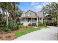 Charming two-story home with a welcoming front porch and beautifully landscaped front yard at 2648 Seabrook Island Rd, Seabrook Island, SC 29455