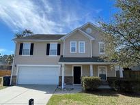 Charming two-story home featuring a two-car garage and well-maintained lawn at 4804 Coopers Ct, Summerville, SC 29485